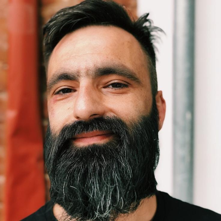 Ava Rios, Lead Design Curator at WanderPacketBuild, reviewing corporate floral arrangements